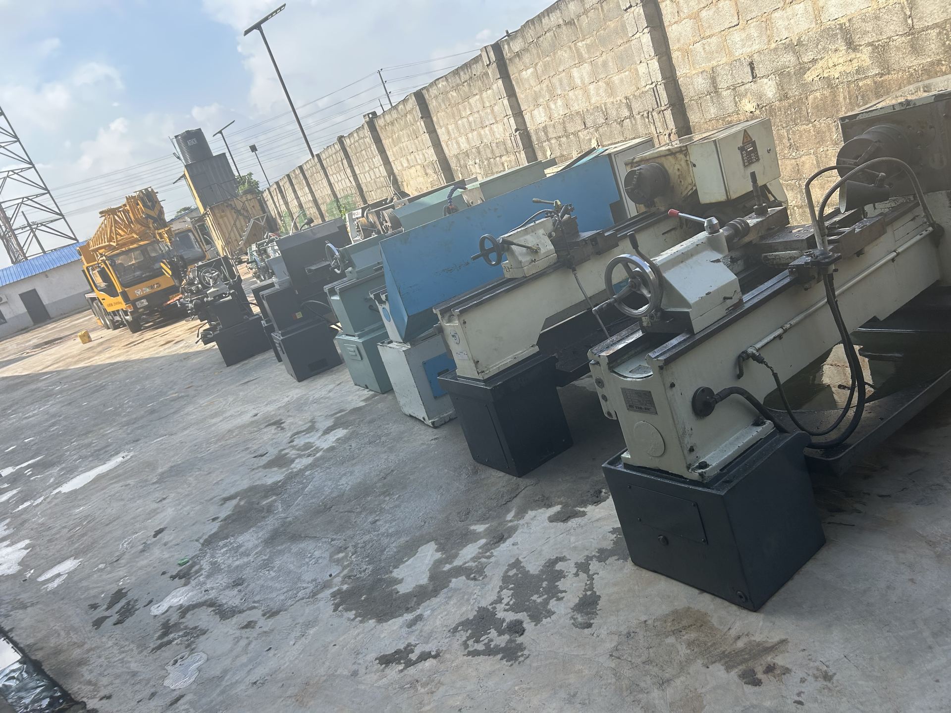 Row of lathe machines lined up in the yard after offloading