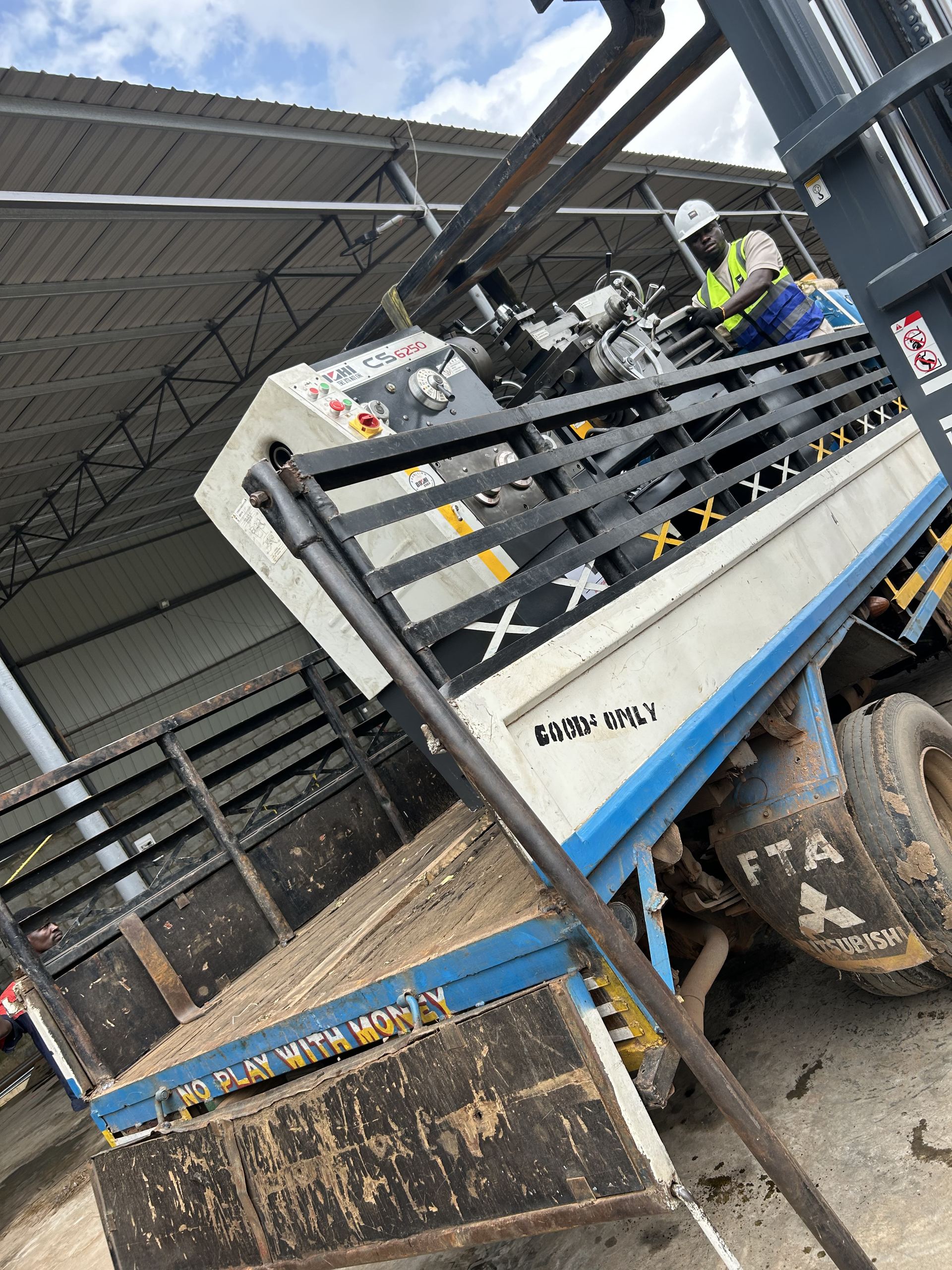 Lathe machine being loaded onto the delivery truck